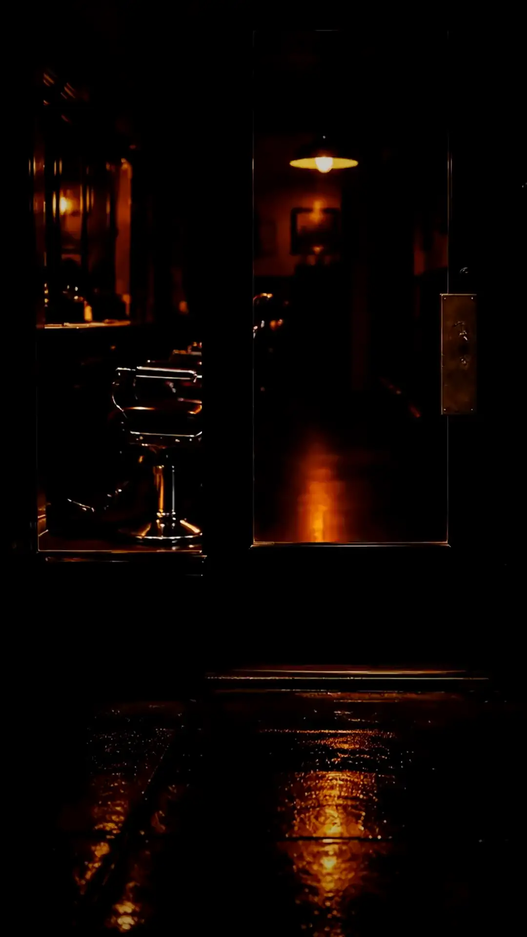 The door of Candil at night, one warm light inside